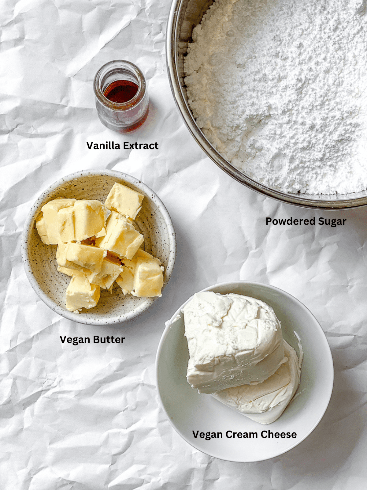 ingredients for Vegan Cream Cheese Frosting measured out on a white surface