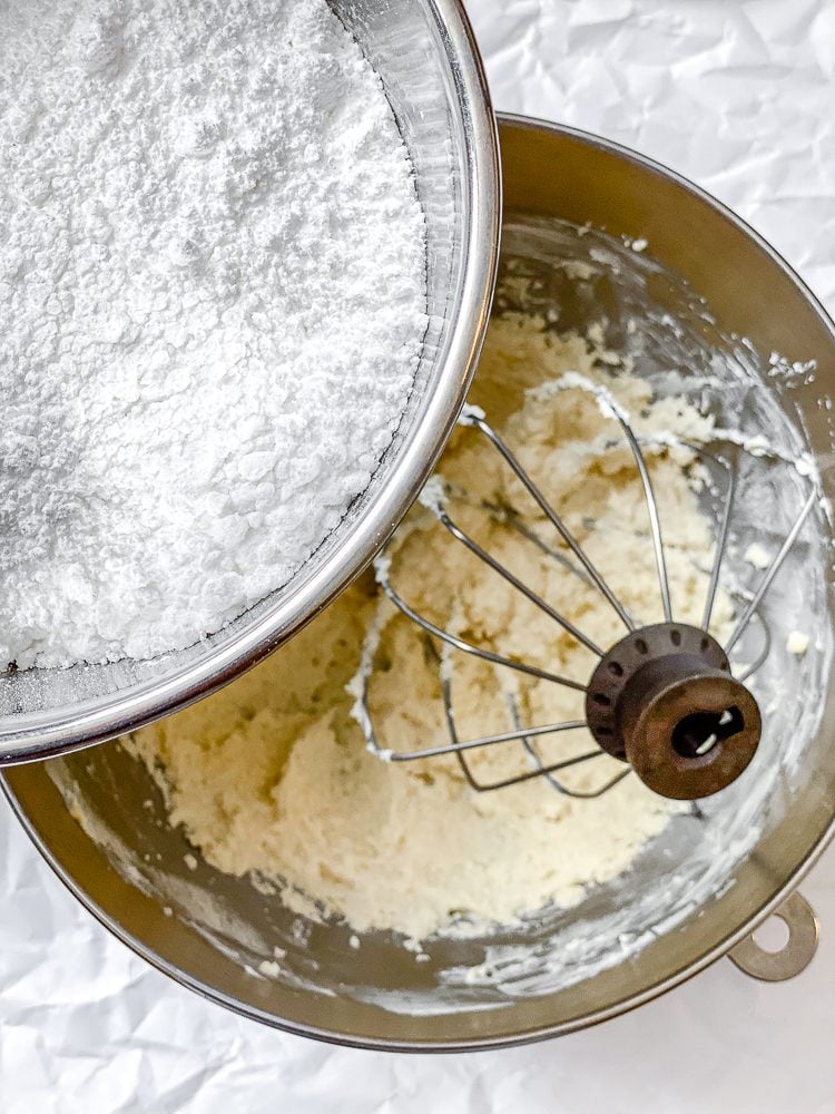 process shot showing adding powdered sugar to bowl