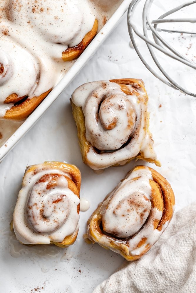 completed Vegan Pumpkin Cinnamon Rolls on a white surface