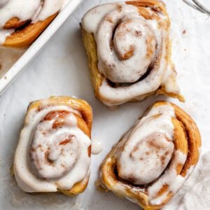 completed Vegan Pumpkin Cinnamon Rolls on a white surface