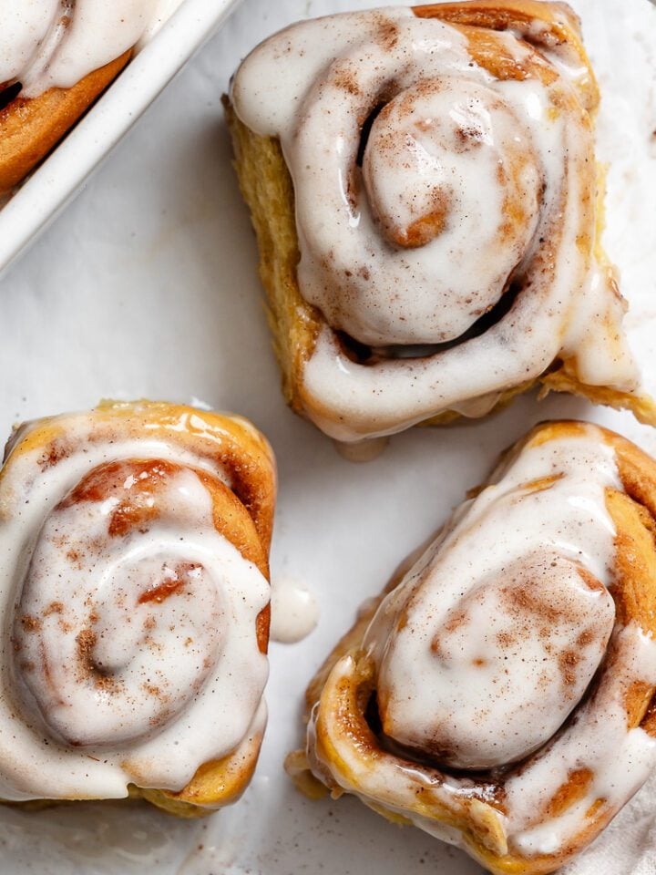 completed Vegan Pumpkin Cinnamon Rolls on a white surface