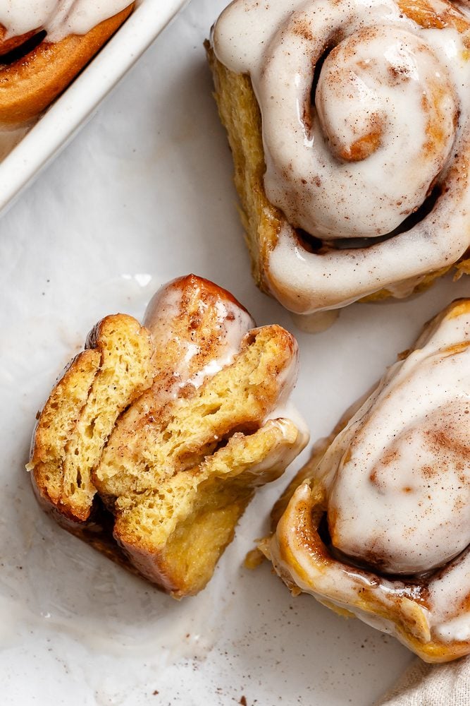 completed Vegan Pumpkin Cinnamon Rolls on a white surface