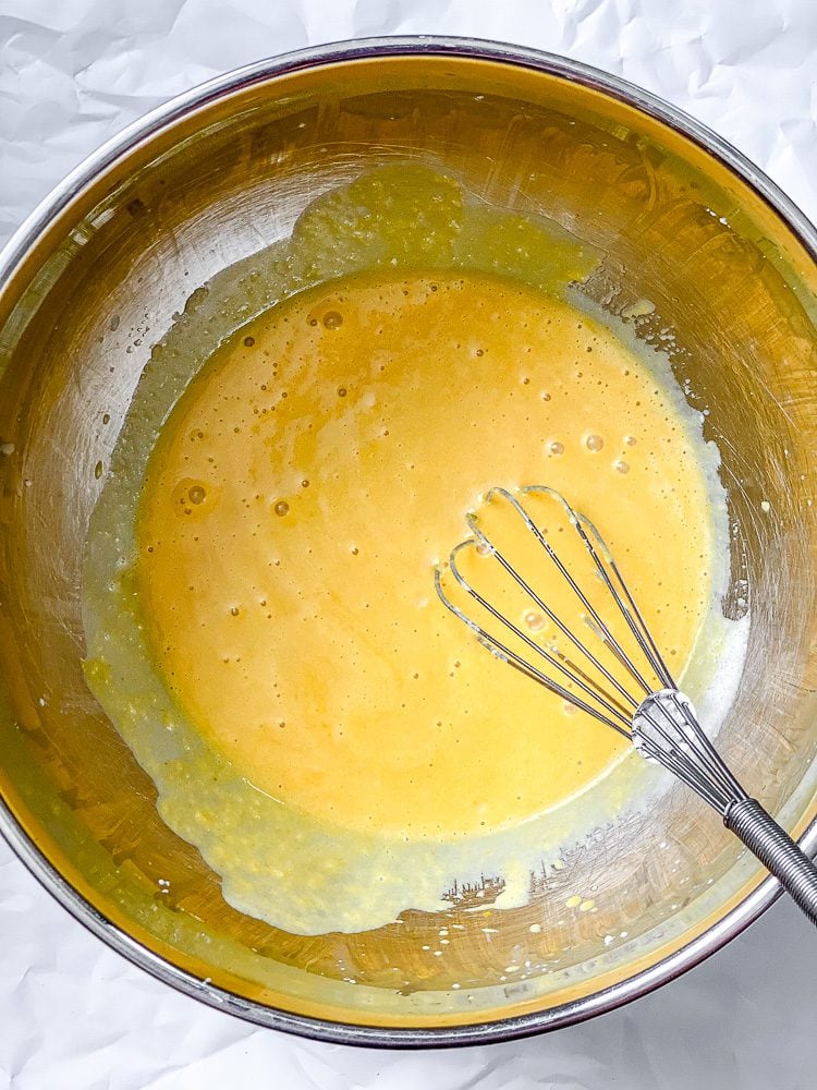 process shot showing mixing ingredients together in bowl