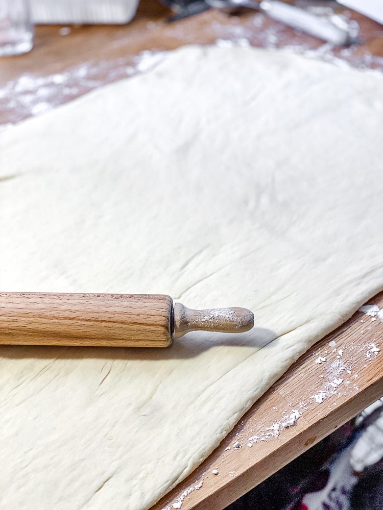 process shot showing rolling out dough on surface