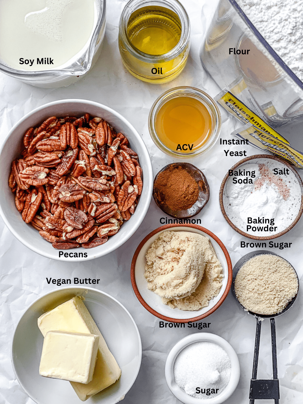 ingredients for Pecan Cinnamon Sticky Buns measured out on a white surface