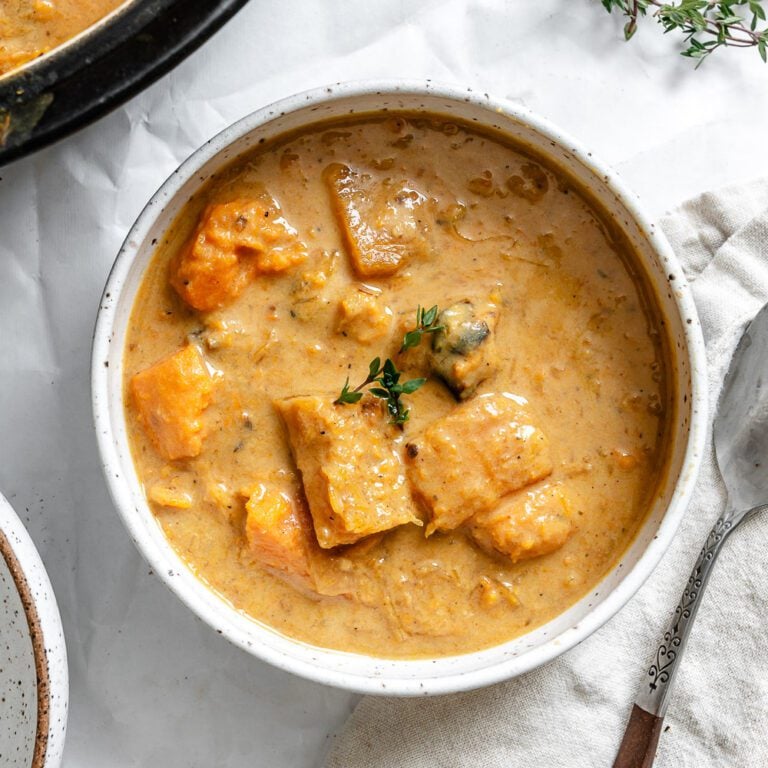 completed Sweet Potato Pumpkin Soup in a bowl alongside pot