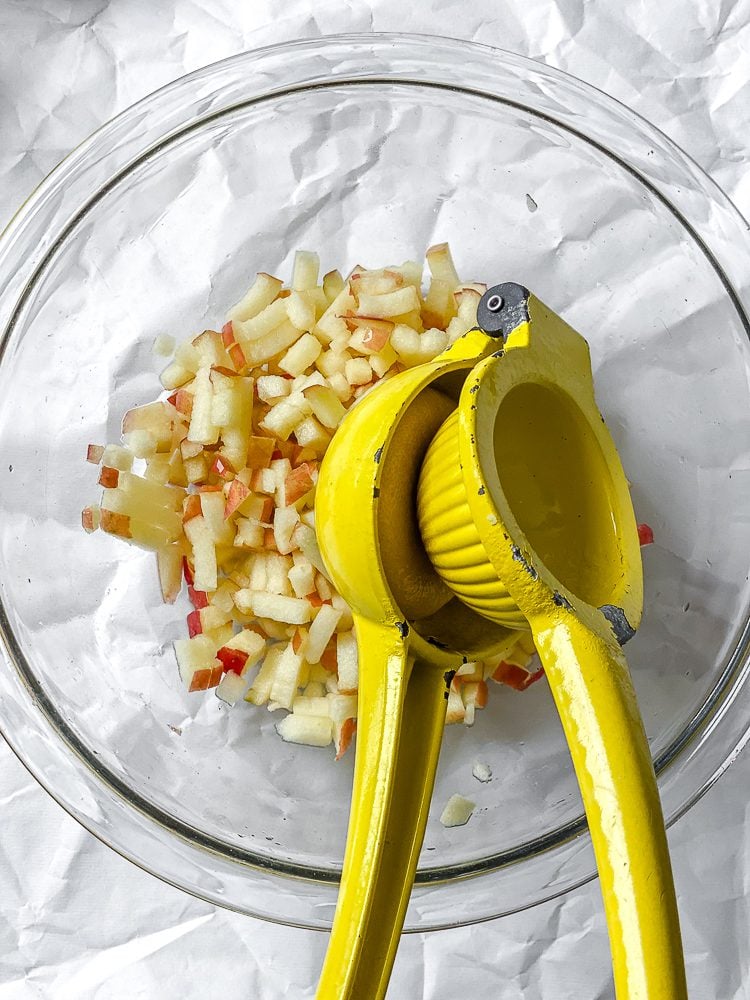 process shot showing adding lemon to bowl