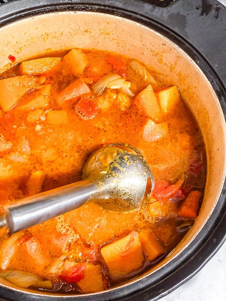 process shot showing using immersion blender in a bowl