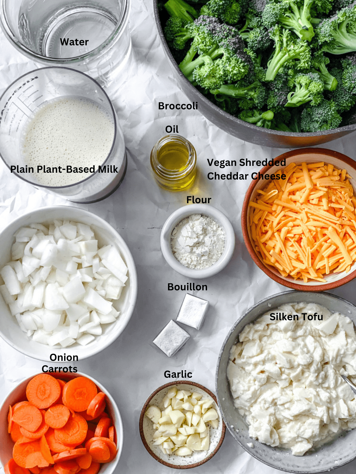 ingredients for Vegan Broccoli Cheddar Soup measured out on a white surface