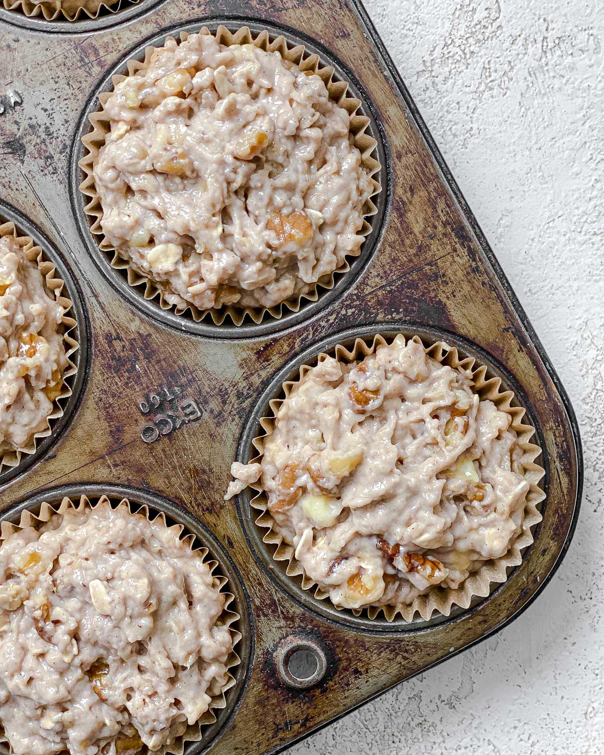 process shot showing pre-baked muffins in muffin tin