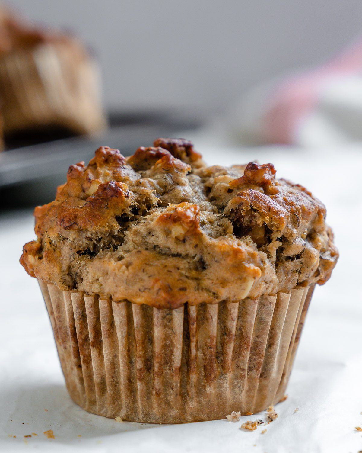 completed Vegan Banana Oatmeal Muffin on a white surface