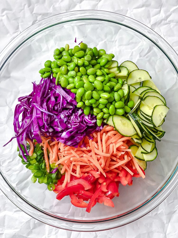 Process shot showing ingredients added to a bowl.