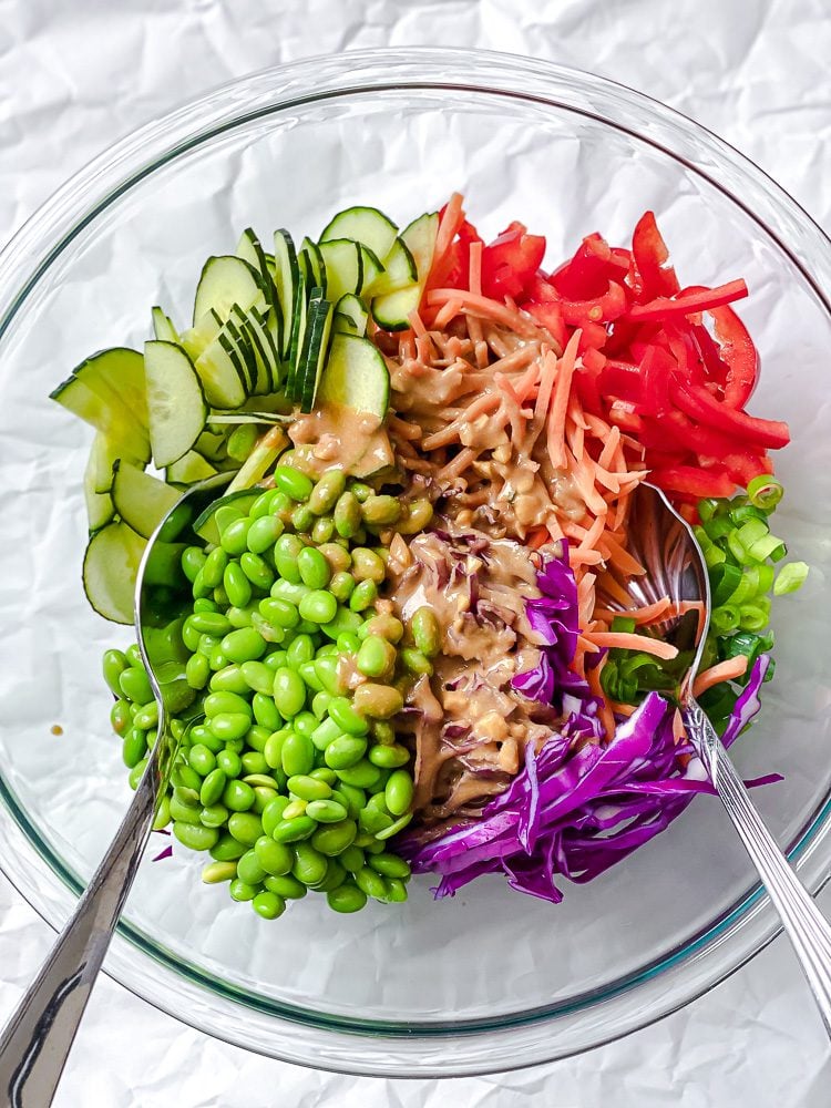 Process shot showing ingredients added to a bowl.