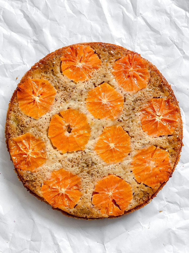 completed Orange Upside Down Cake on a white surface