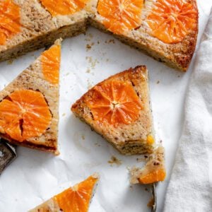 completed Orange Upside Down Cake on a white surface in slices