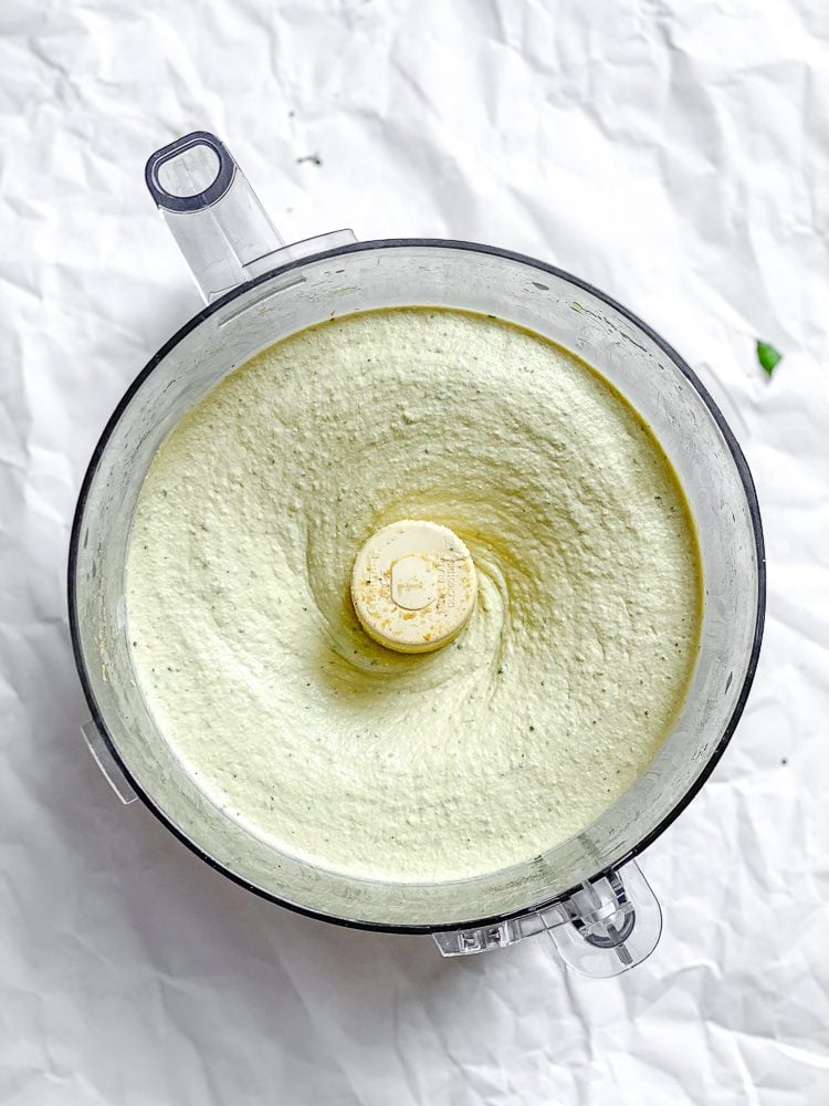 Process shot showing tofu ricotta in food processor.