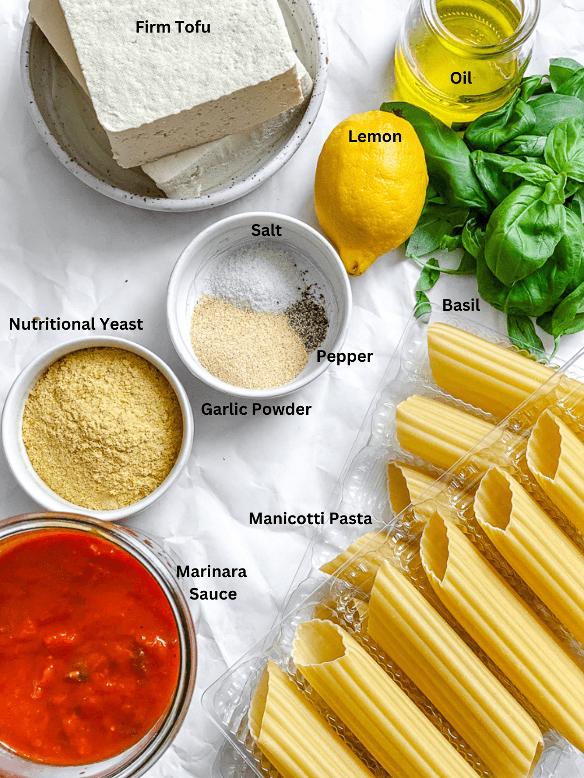 Ingredients for Vegan Manicotti (With Tofu Ricotta) measured out on a white surface.