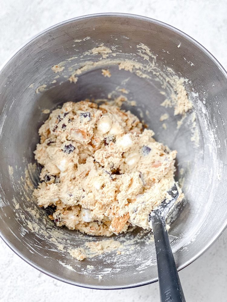 Process shot showing mixing ingredients together in a bowl.