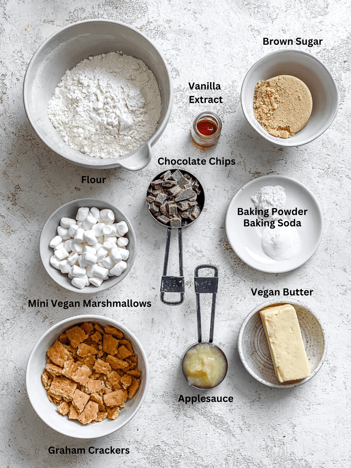 Ingredients for Vegan Smores Cookies measured out on a white surface.