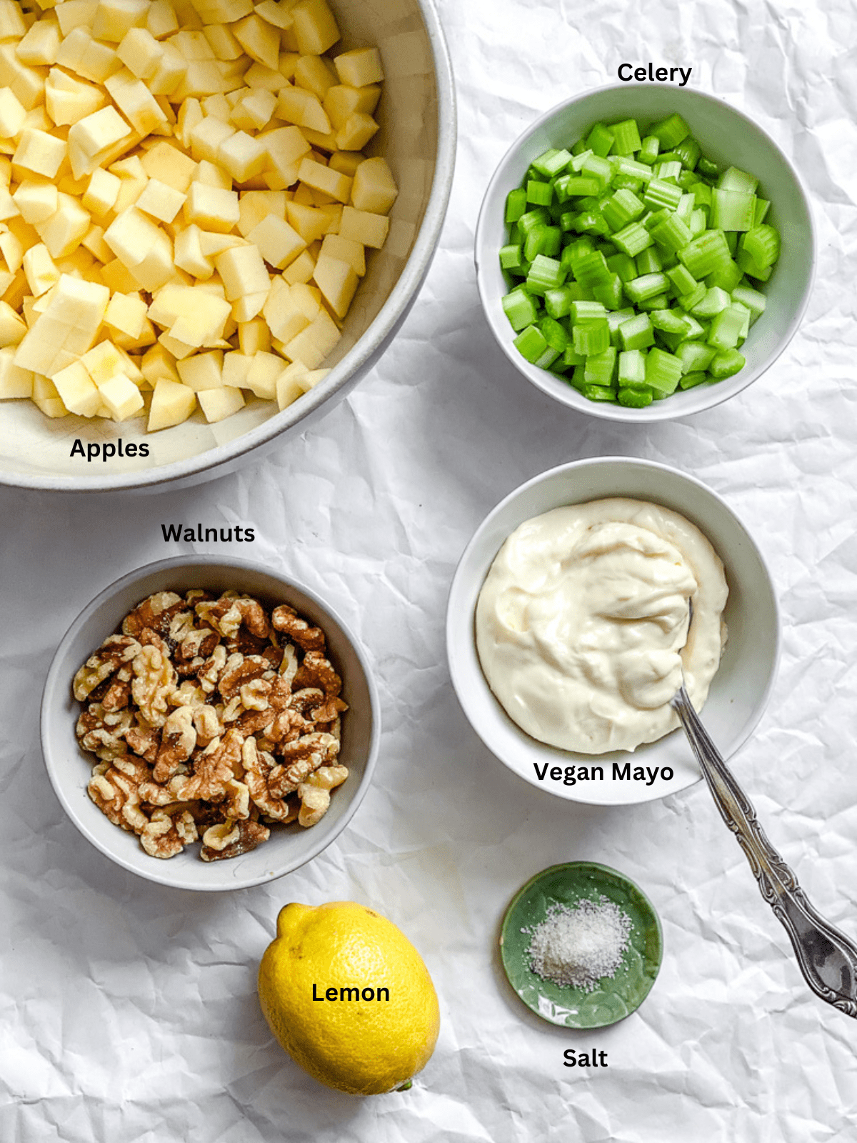 Ingredients for Vegan Waldorf Salad measured out on a white surface.