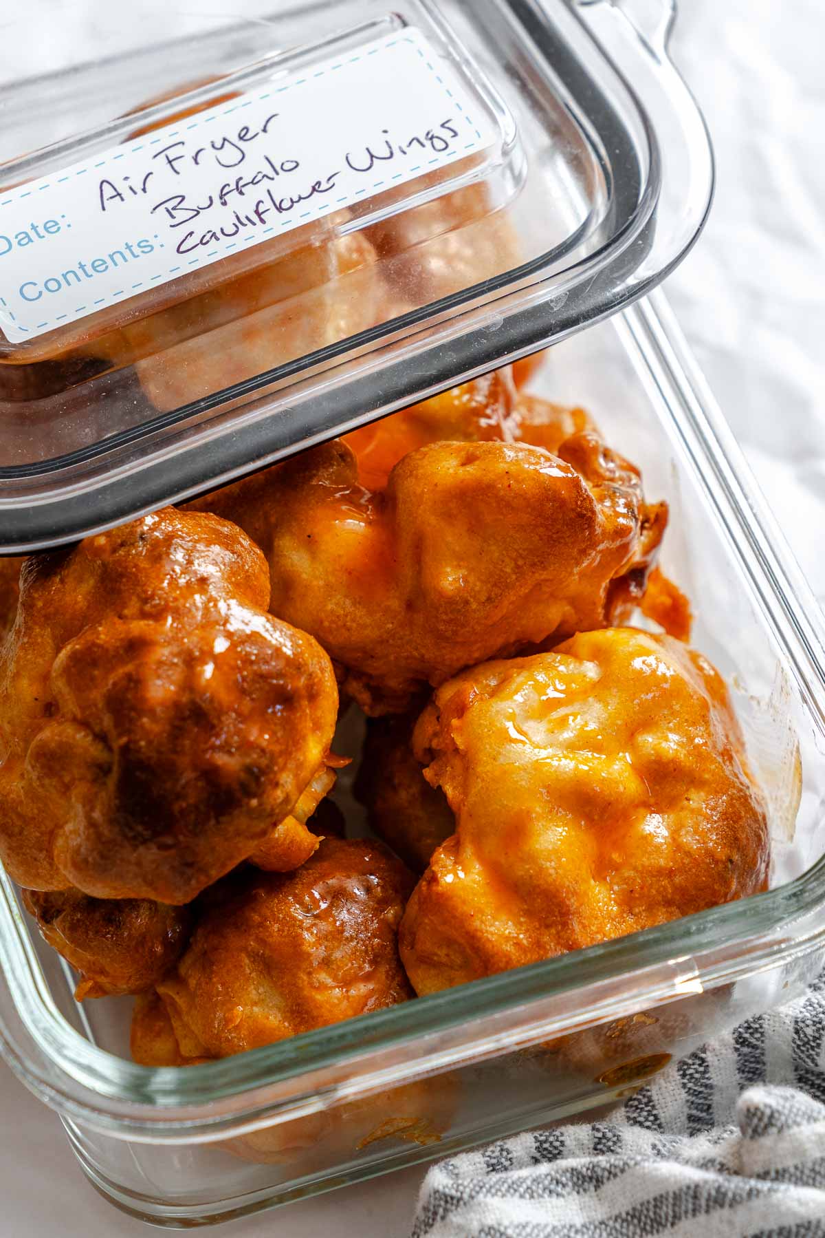 Completed Air Fryer Buffalo Cauliflower Wings in a storage container.