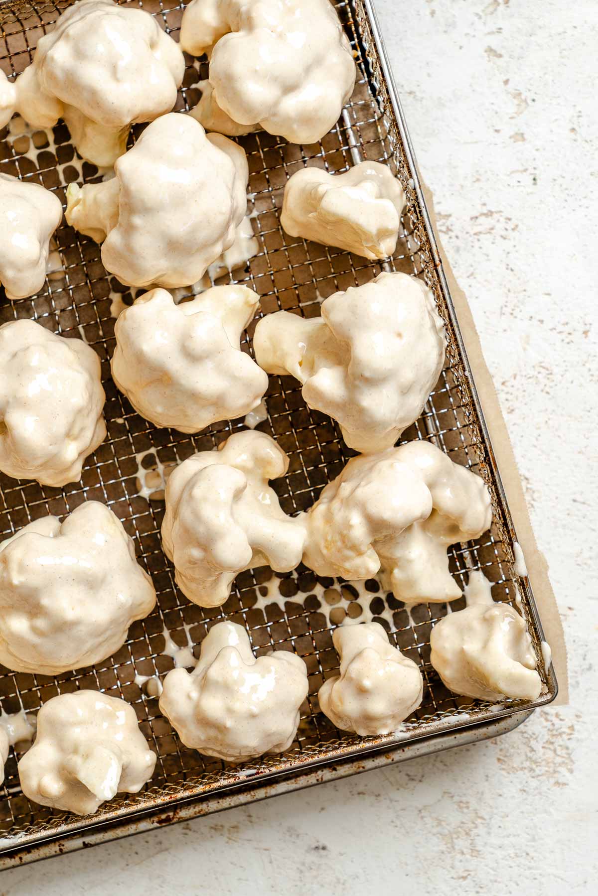 Process shot showing cauliflower on air fryer rack.
