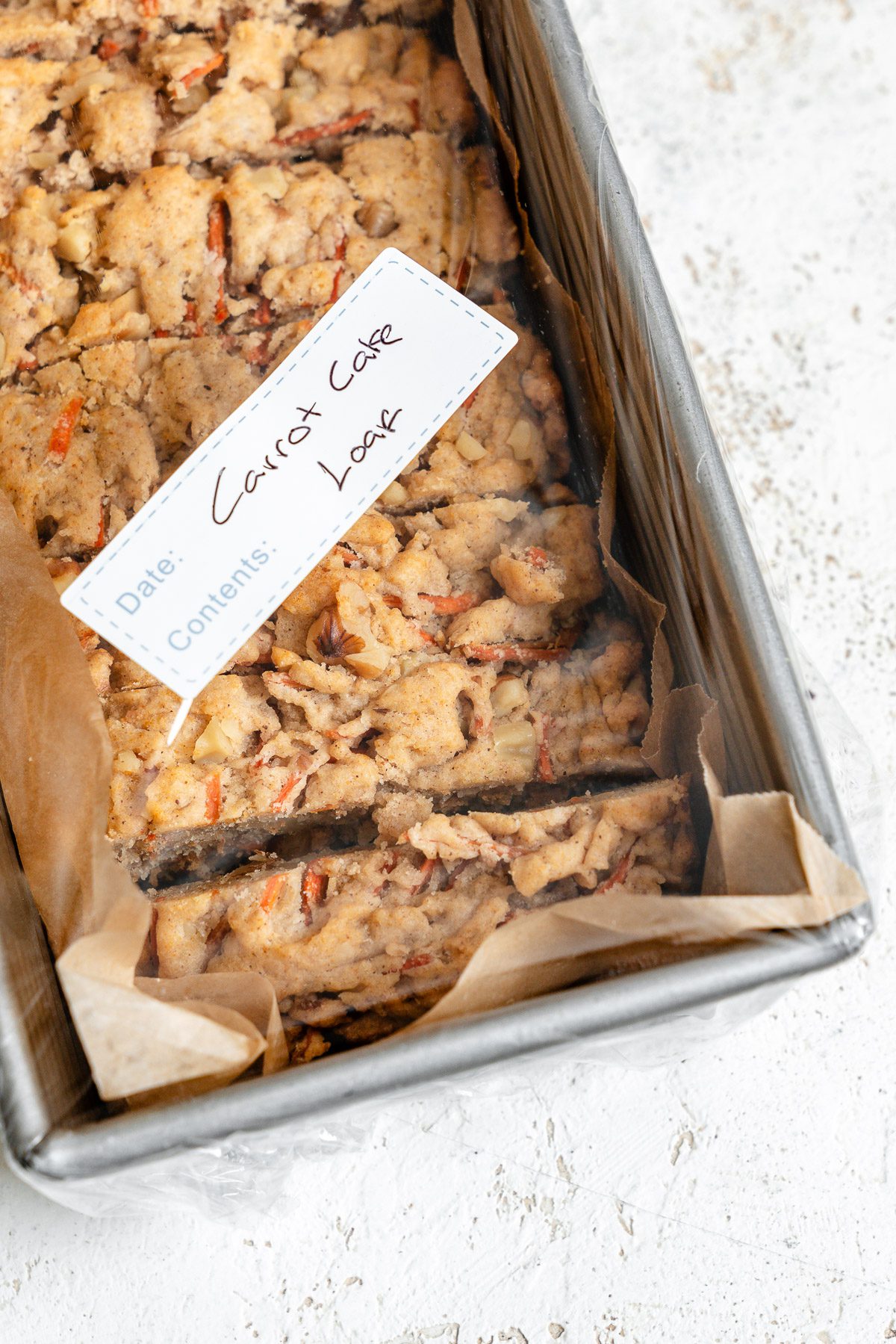Completed Vegan Carrot Cake Loaf in a storage container.