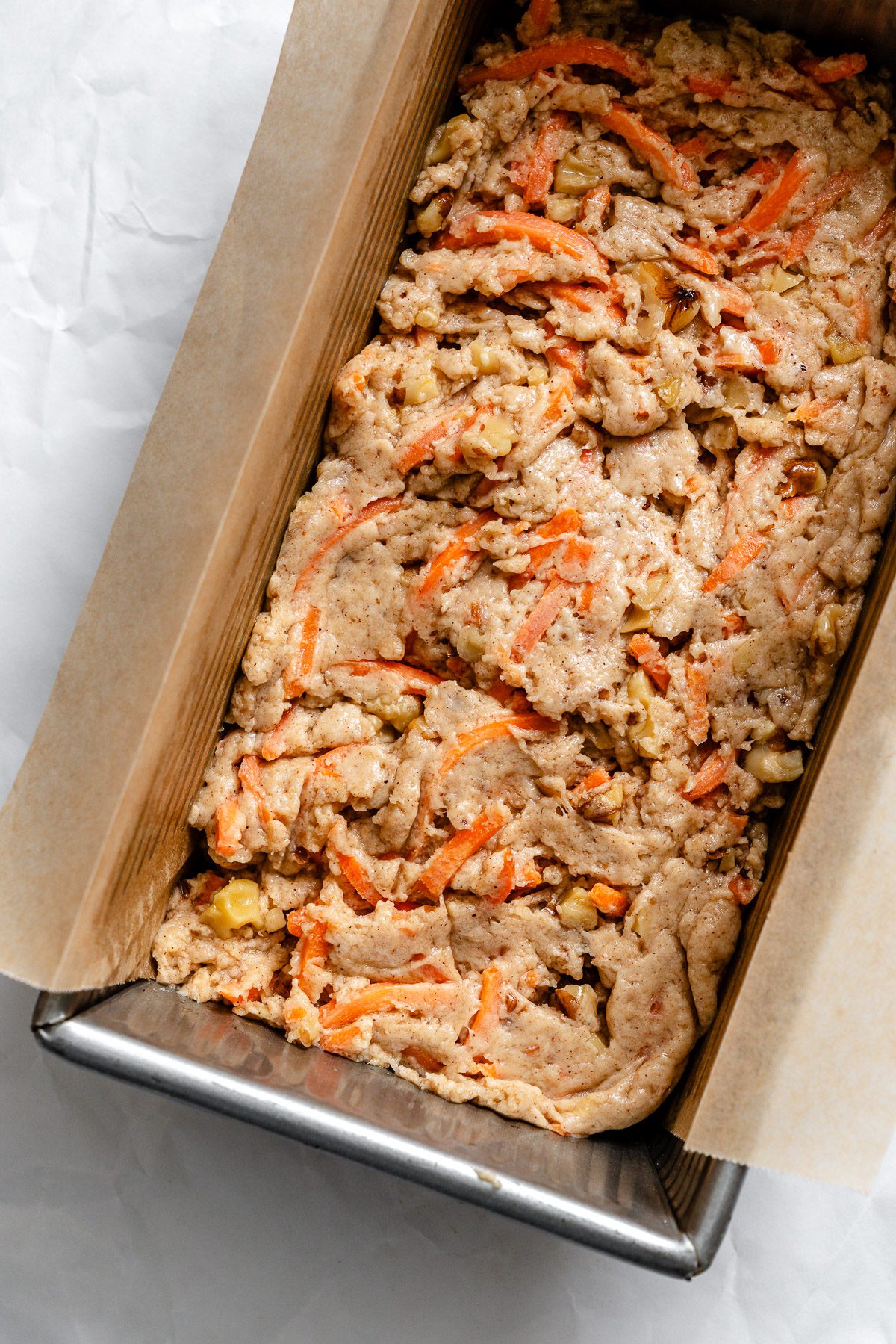 Process shot showing batter added to baking pan.