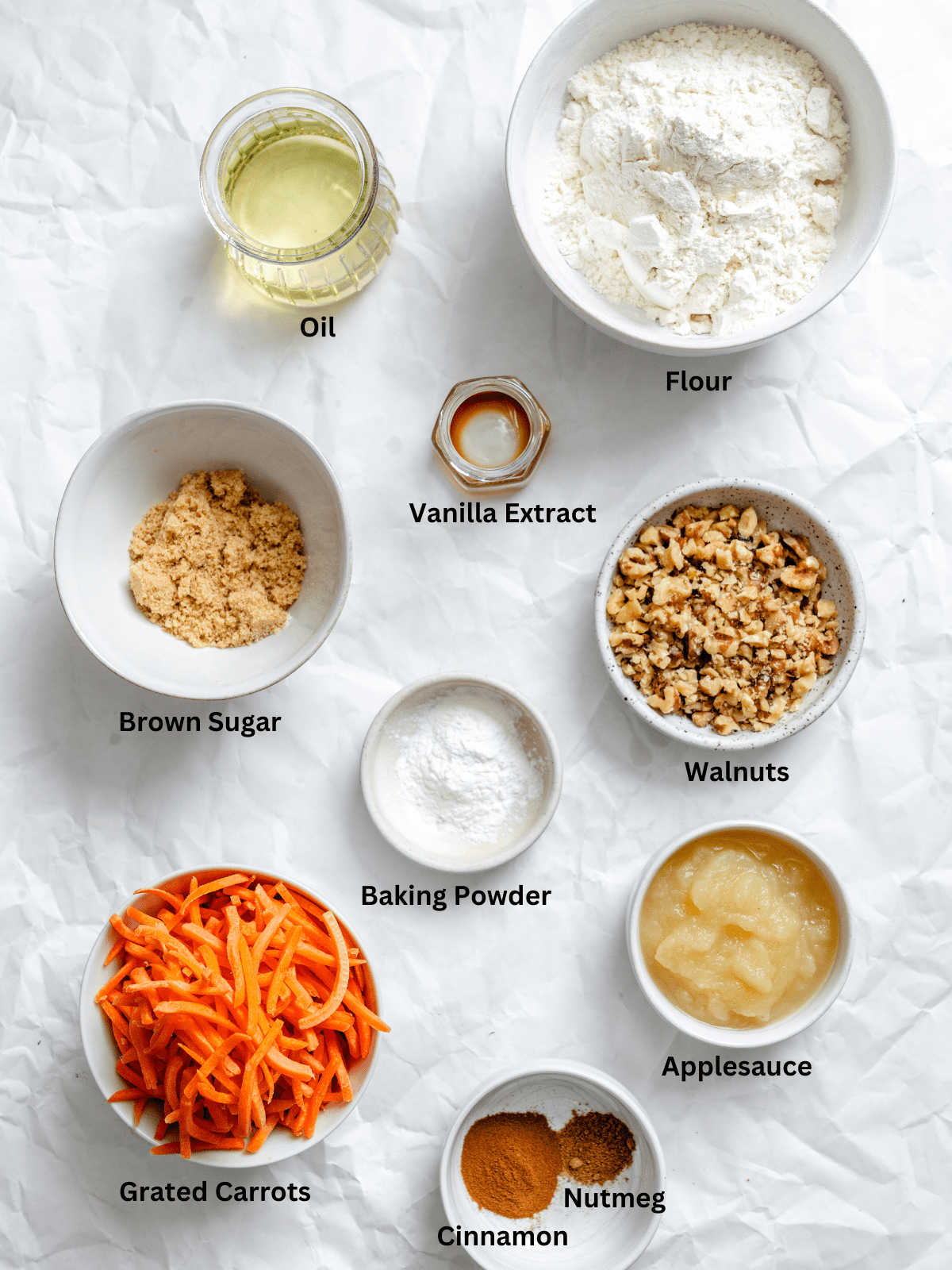 Ingredients for Vegan Carrot Cake Loaf measured out on a white surface.