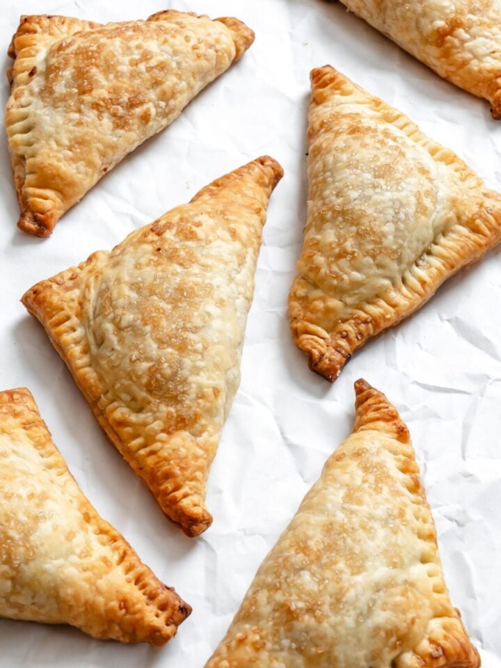 Process shot showing completed Vegan Apple Turnovers on a white surface.