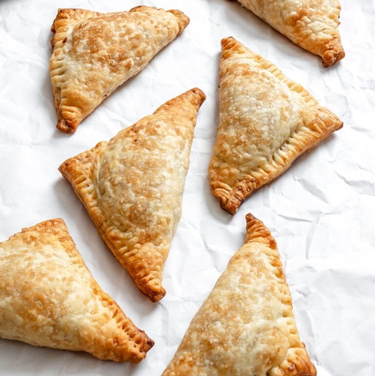 Process shot showing completed Vegan Apple Turnovers on a white surface.