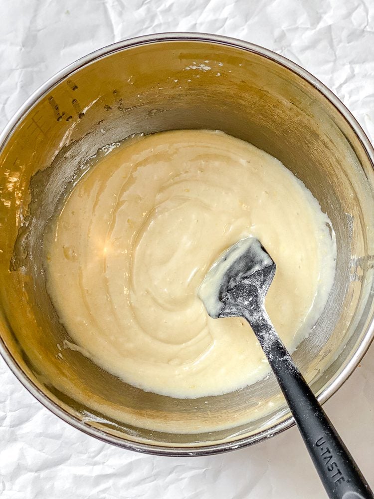 Process shot showing mixing ingredients in a bowl.