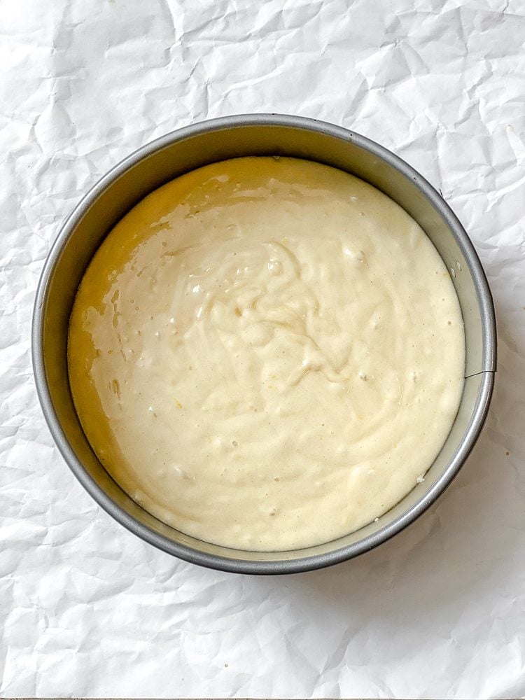 Process shot showing batter added to baking pan.