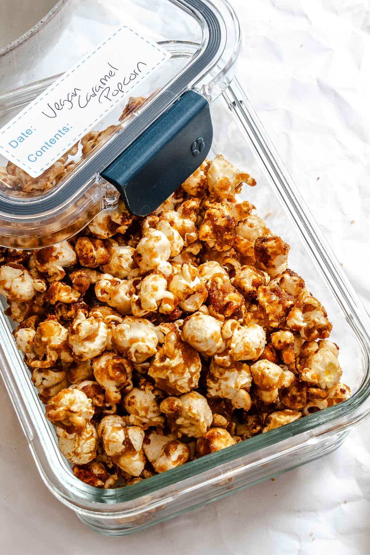 Completed Vegan Caramel Popcorn in a storage container.