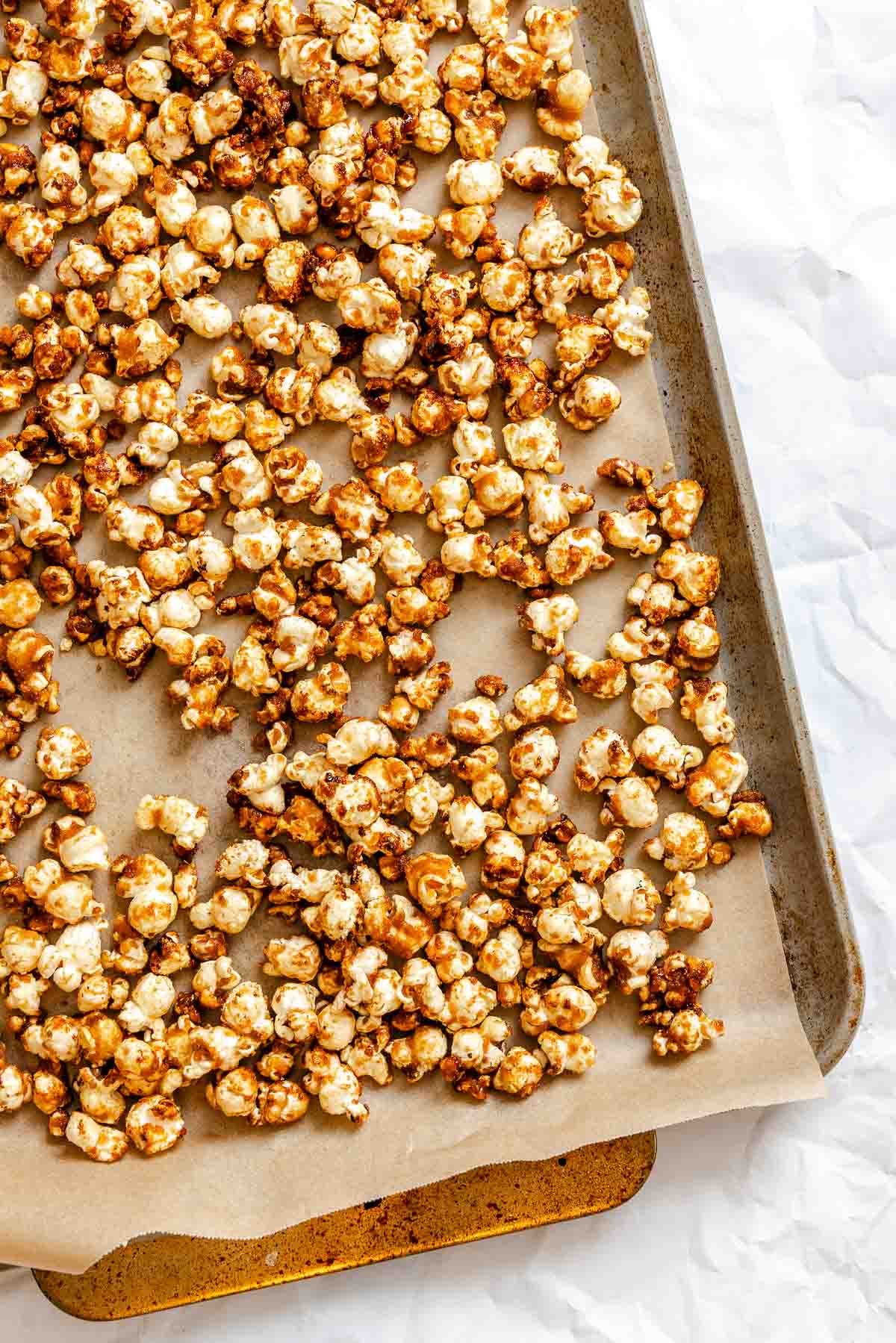 Process shot showing popcorn in a baking sheet.