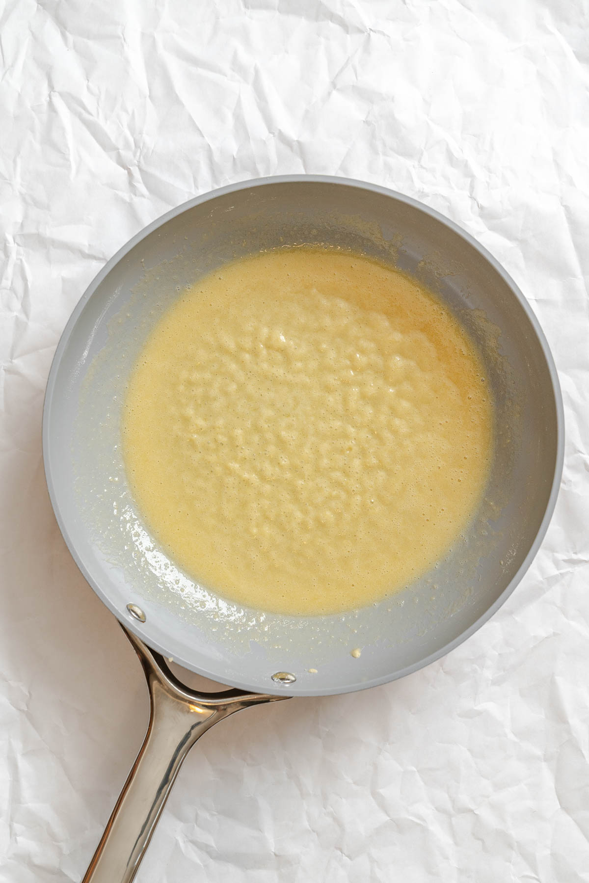 Golden, bubbly roux of vegan butter and flour in a saucepan.