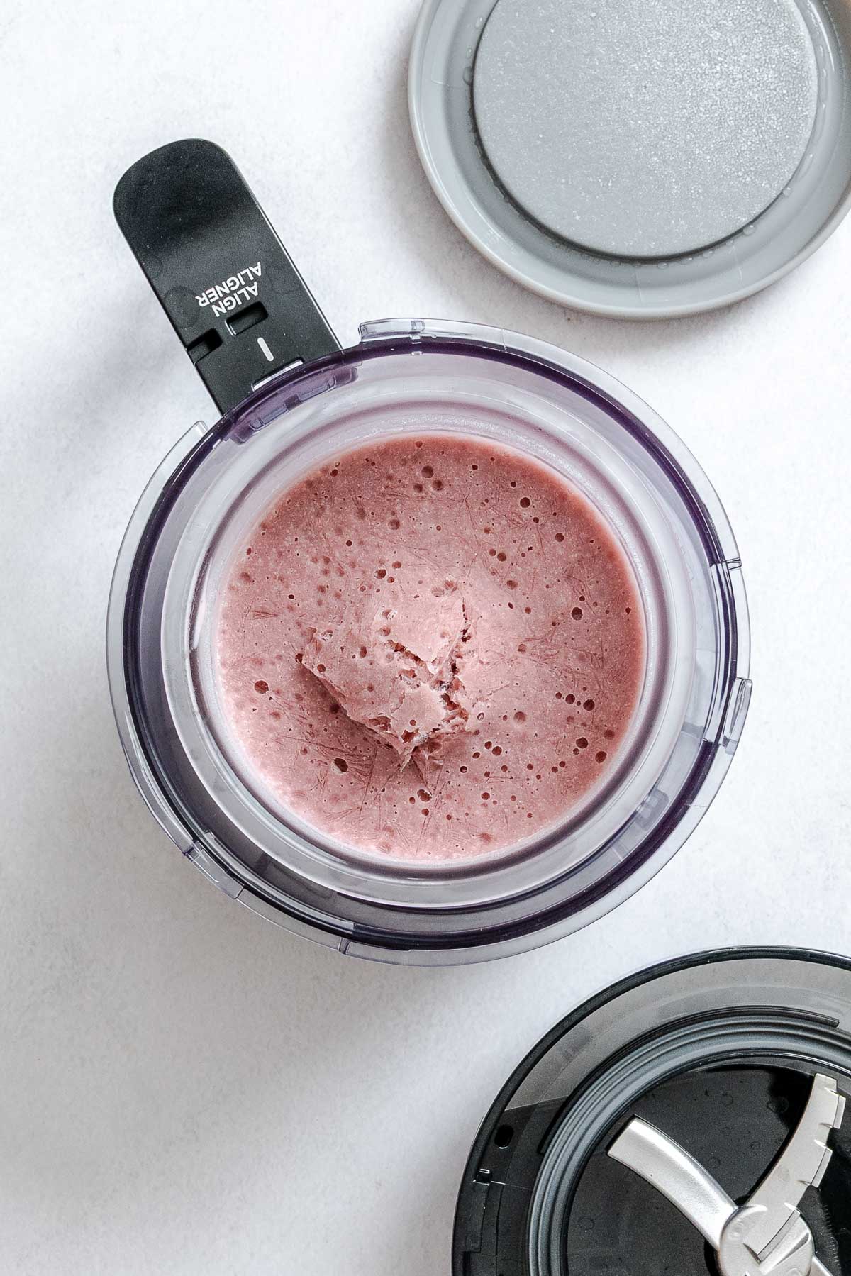 Process shot showing the Vegan Strawberry Ice Cream (Ninja Creami)-5 in the ninja creami maker.