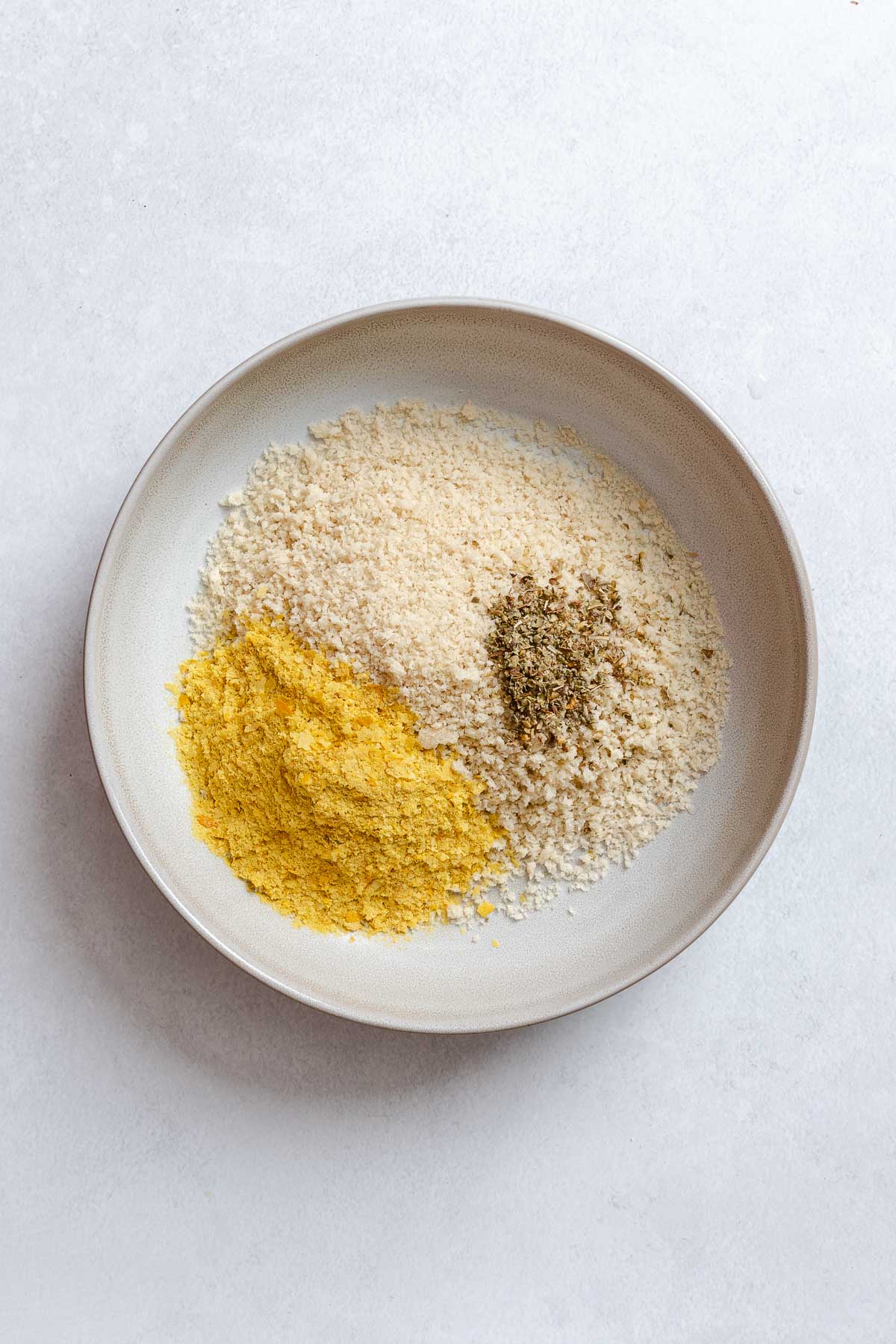 Process shot showing panko mixture in bowl.