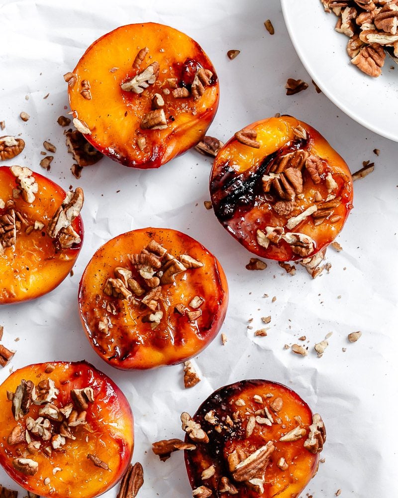 Completed Easy Grilled Peaches on a white surface.