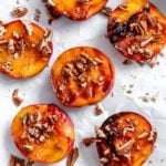 Completed Easy Grilled Peaches on a white surface.