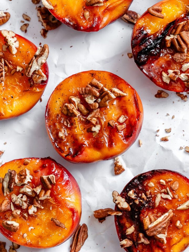 Completed Easy Grilled Peaches on a white surface.