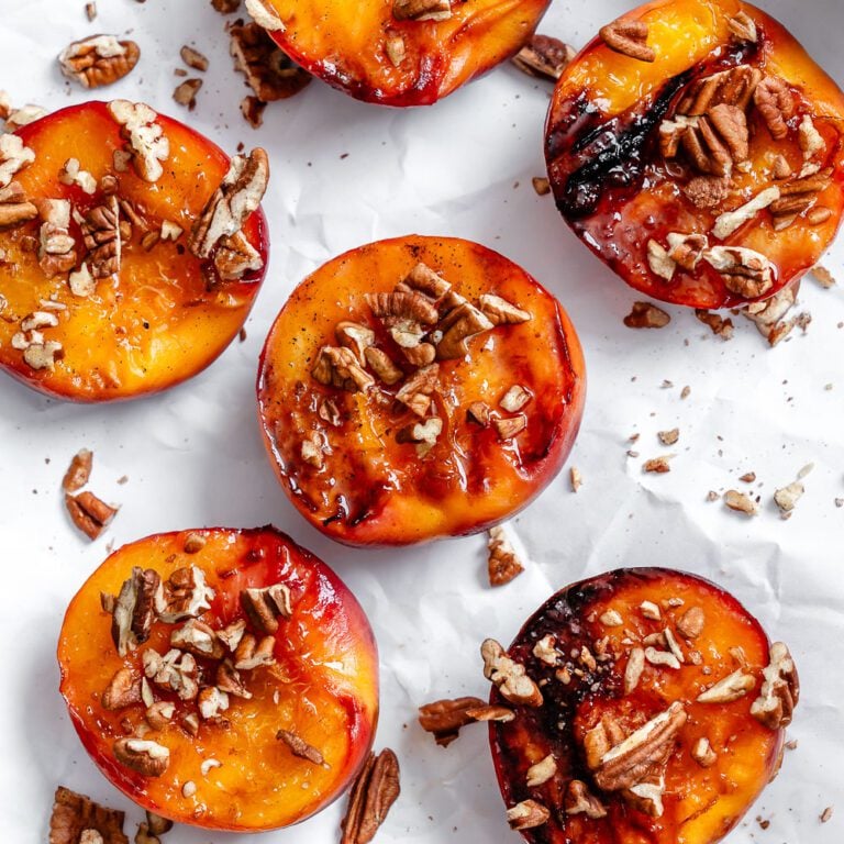 Completed Easy Grilled Peaches on a white surface.
