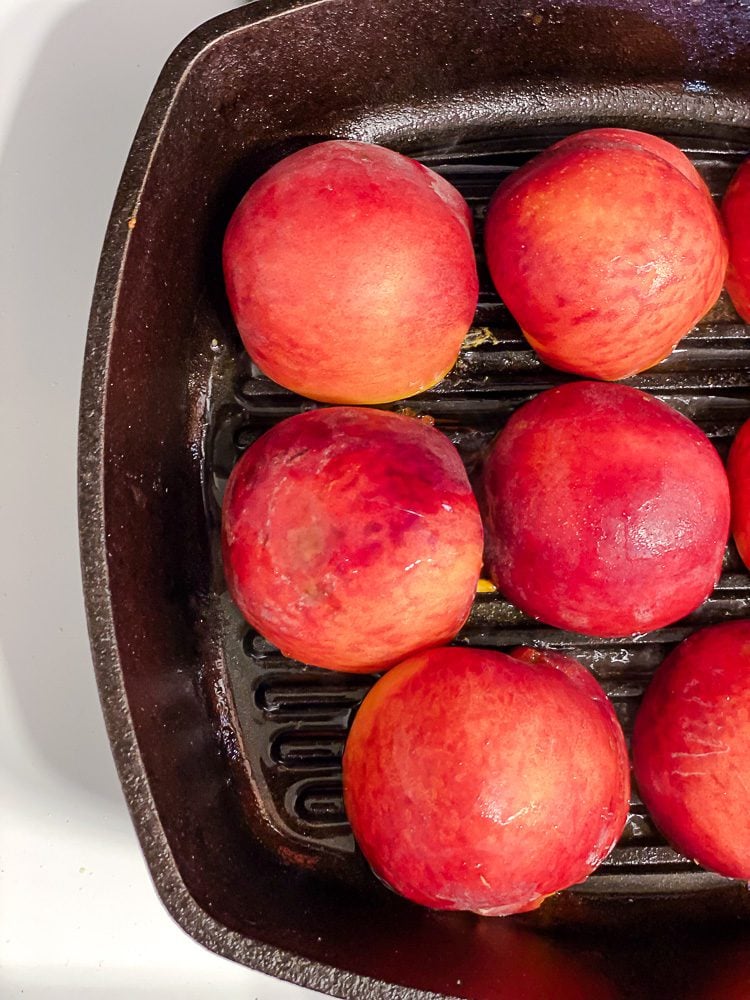 Process shot showing peaches on pan.