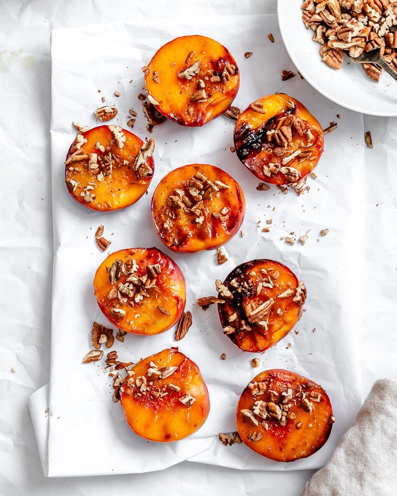 Completed Easy Grilled Peaches on a white surface.