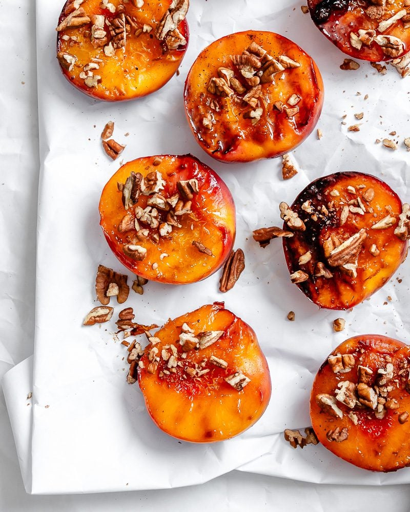 Completed Easy Grilled Peaches on a white surface.