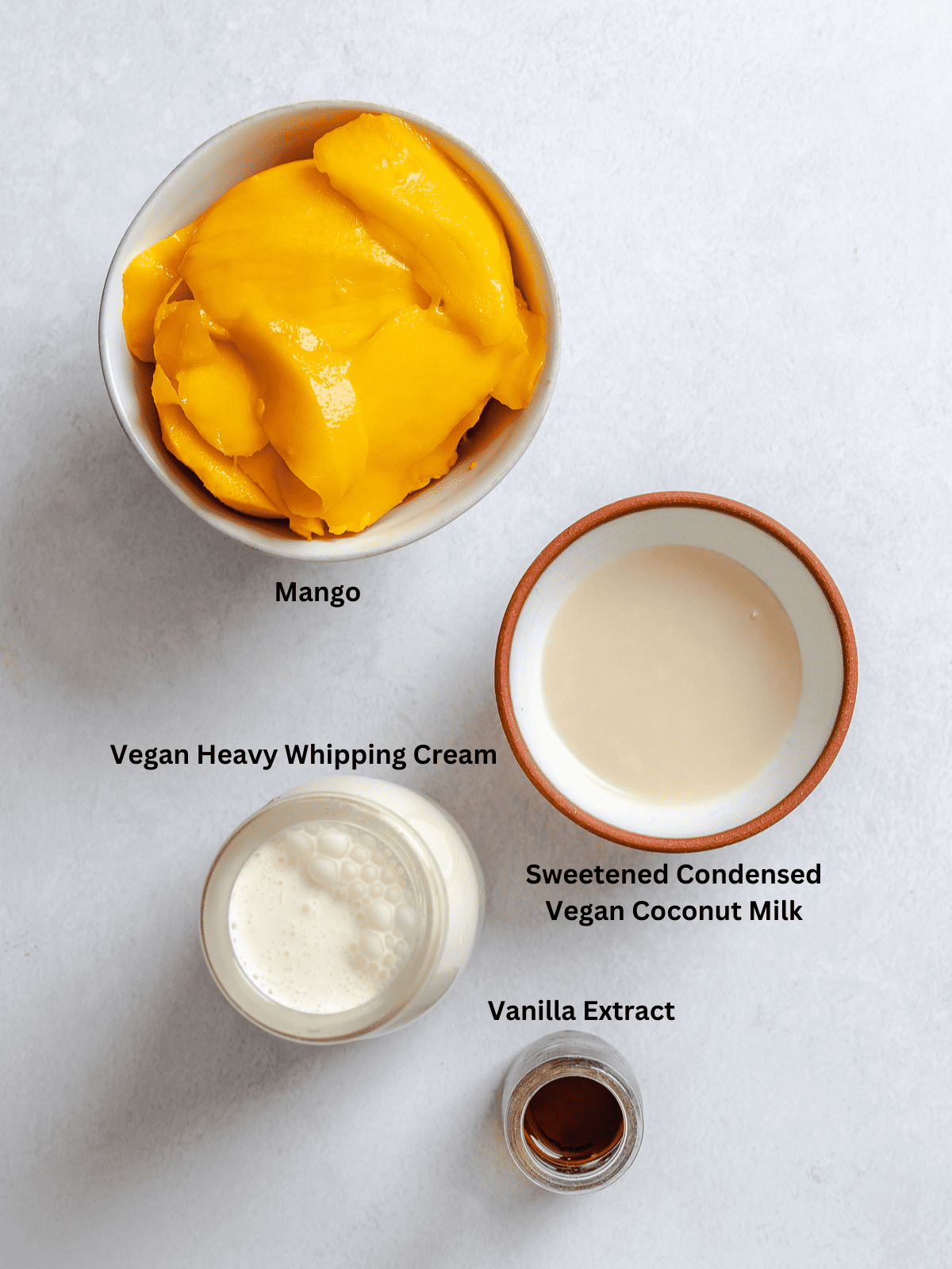 Ingredients for Vegan Mango Ice Cream Ingredients measured out on a white surface.