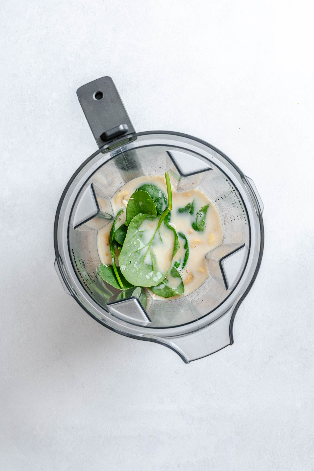 Process shot showing ingredients in a blender.
