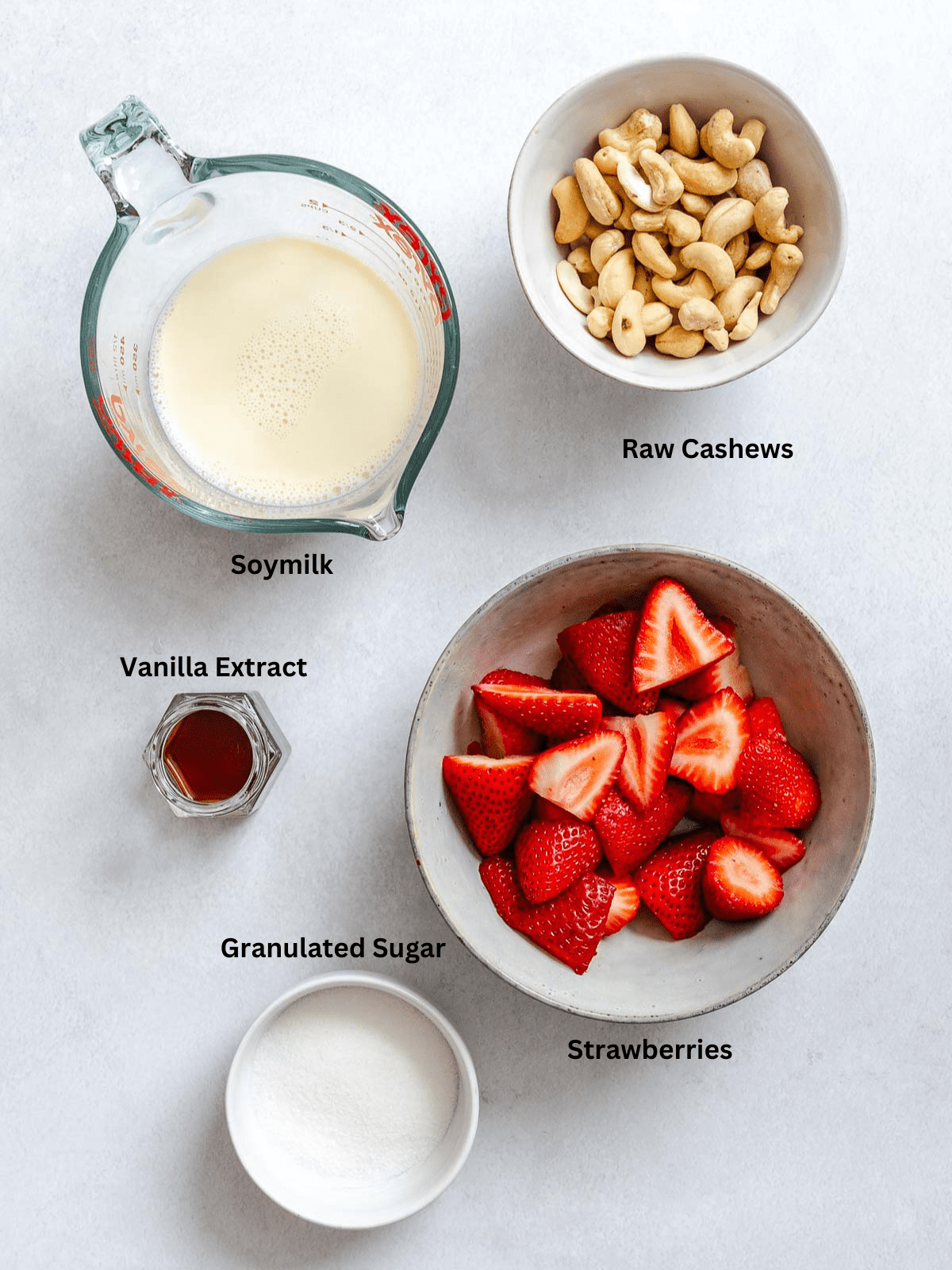 Ingredients for Vegan Strawberry Ice Cream (Ninja Creami) measured out on a white surface.