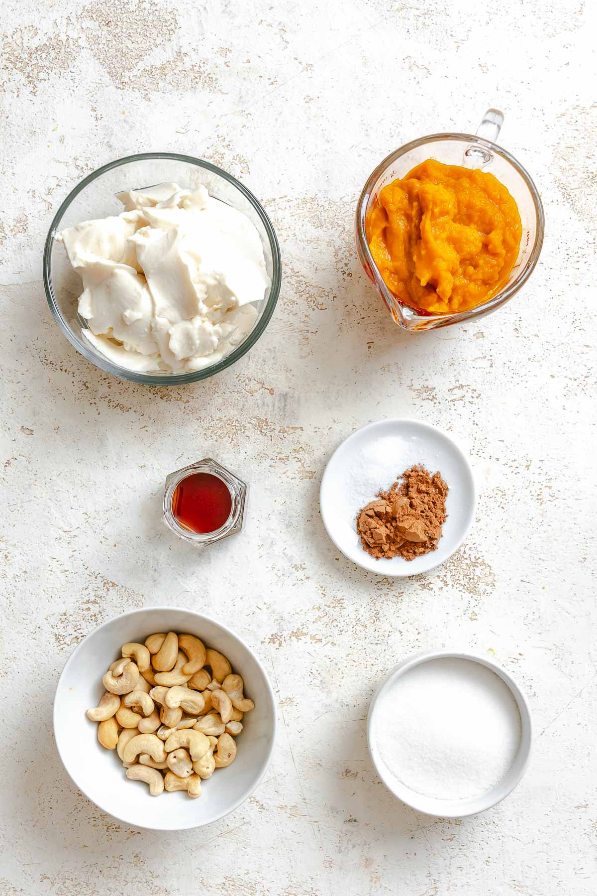 Ingredients for Vegan Pumpkin Ice Cream (Ninja Creami) measured out on a white surface.