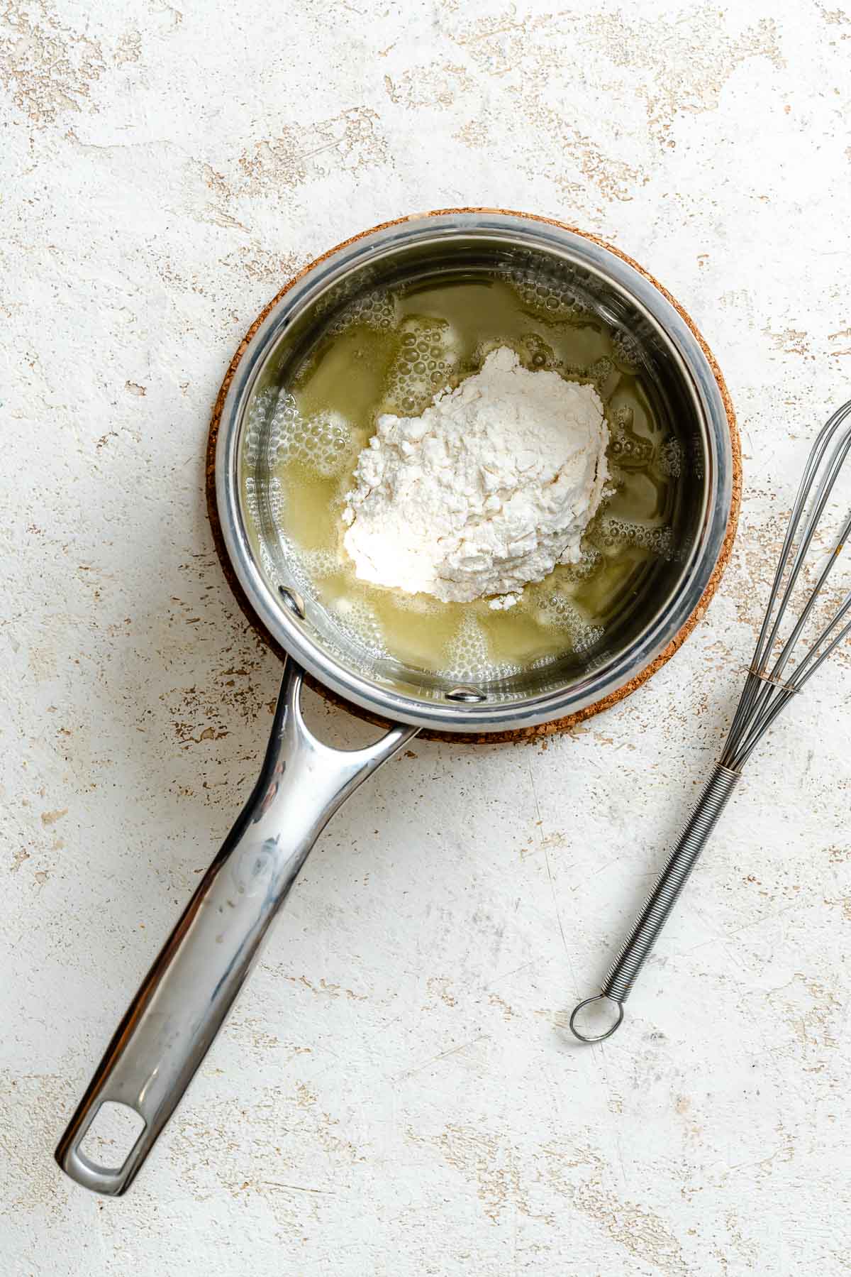 Process shot showing oil and flour in a pan.
